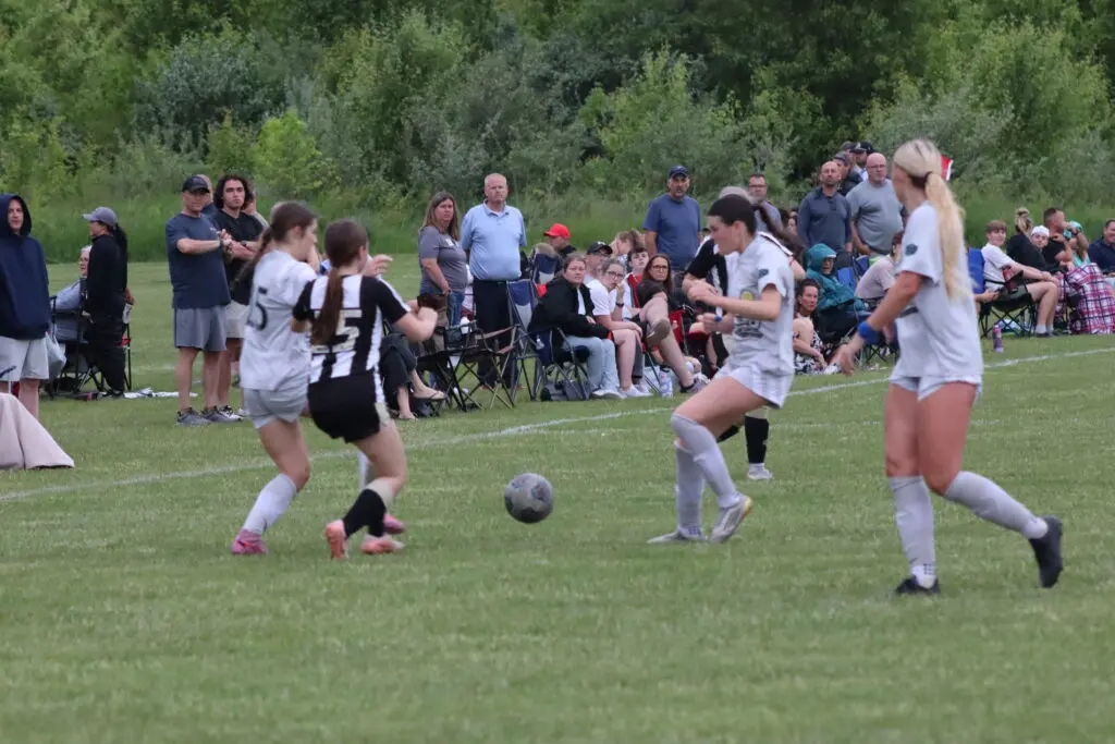 Teenage girls playing soccer.