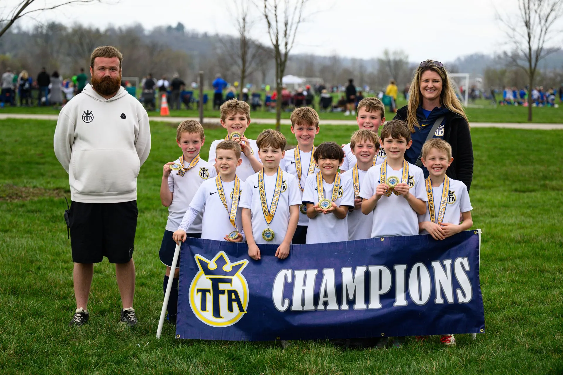 Youth soccer team celebrating with medals.